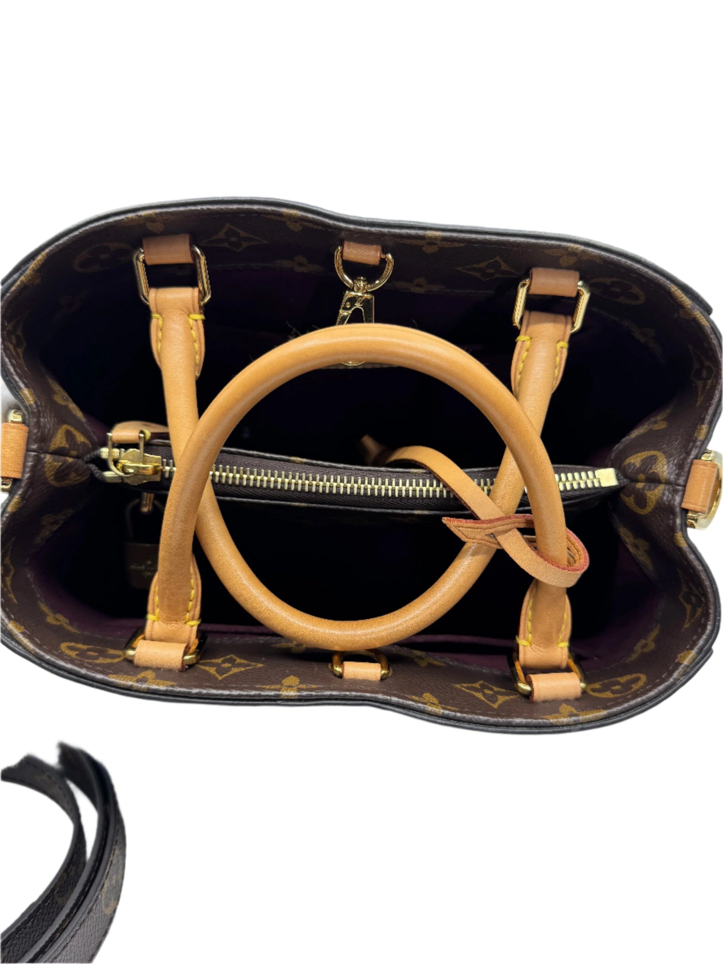 interior-of-louis-vuitton-montaigne-bb-bag-with-two-compartments-and-golden-zipper-divider-with-another-compartment-and-vachetta-leather-strap