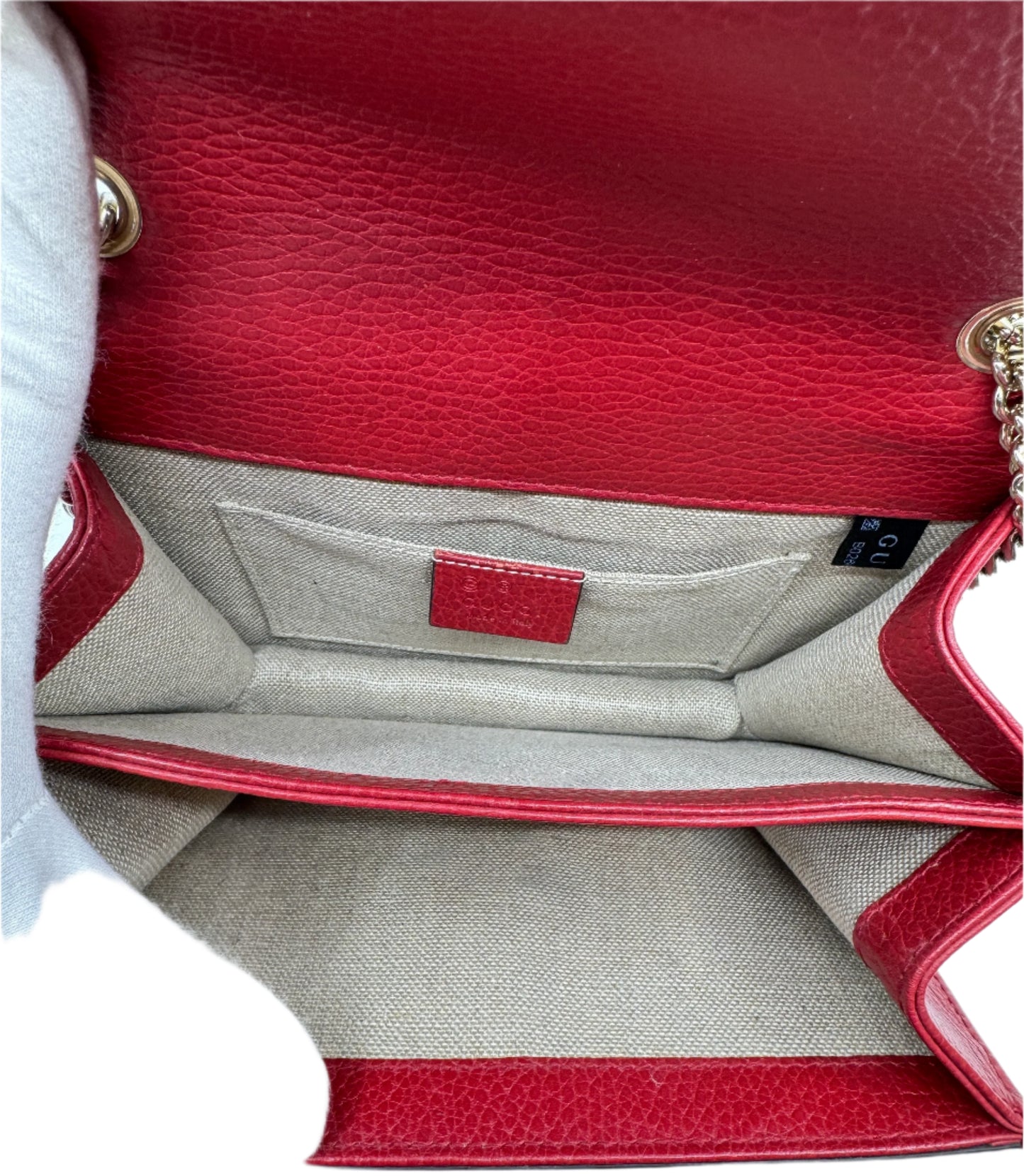 interior-of-the-gucci-small-dollar-interlocking-g-red-in-fabric-with-two-main-compartments-and-small-open-inner-pocket-with-black-brand-tag