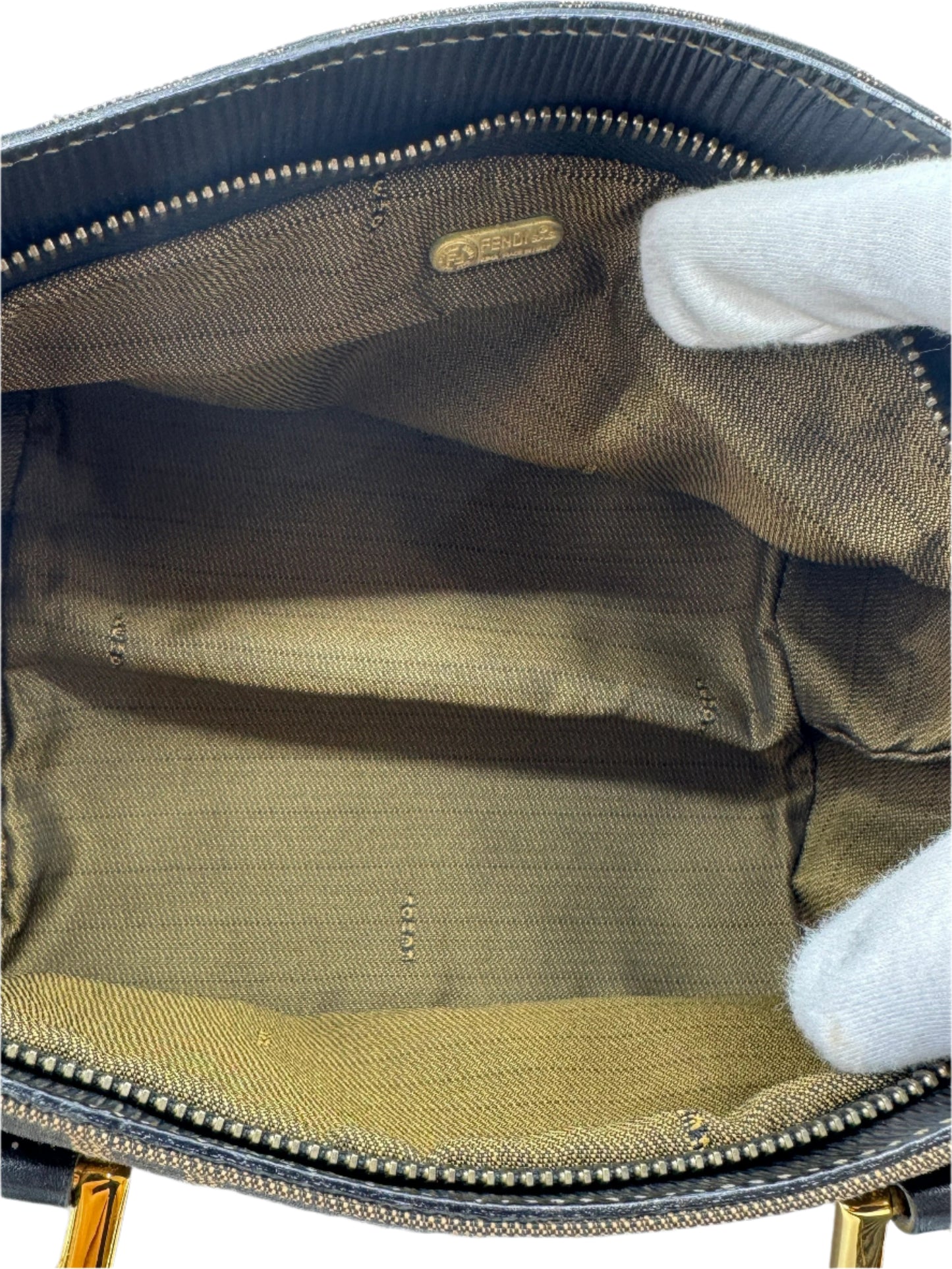 spacious-interior-of-the-fendi-zucca-handbag-in-fabric-with-a-golden-plaque-featuring-the-fendi-logo-ensuring-its-authenticity