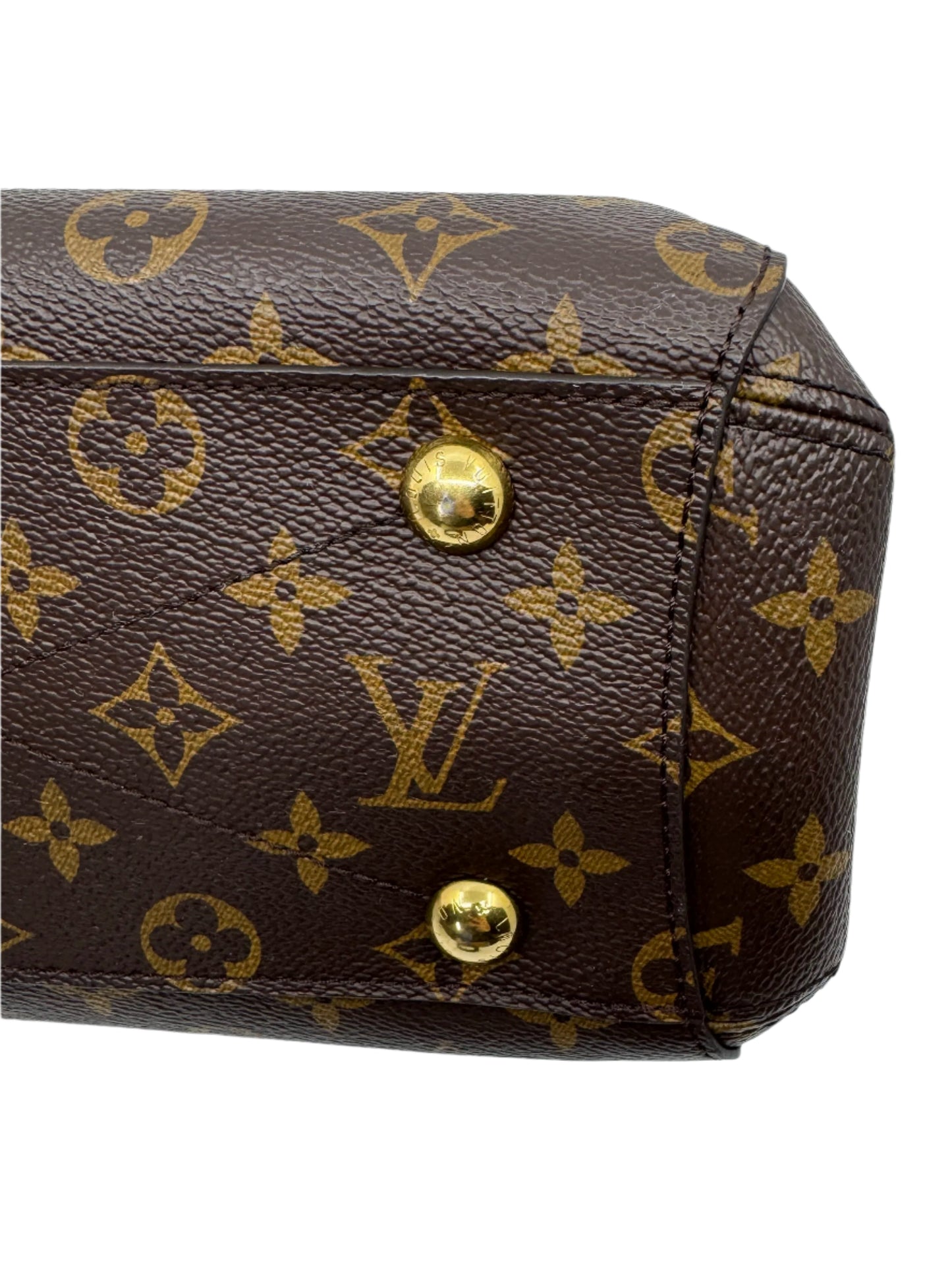 zoom-in-of-two-golden-pins-on-bottom-of-louis-vuitton-montaigne-bb-bag-with-engraved-louis-vuitton-logo