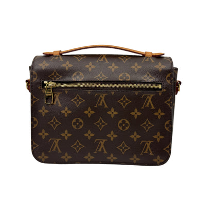 Back-part-of-the-Louis-Vuitton-Metis-Pochette-Monogram-with-small-golden-closure-leather-strap-logo-across-the-bag-and-shoulder-strap