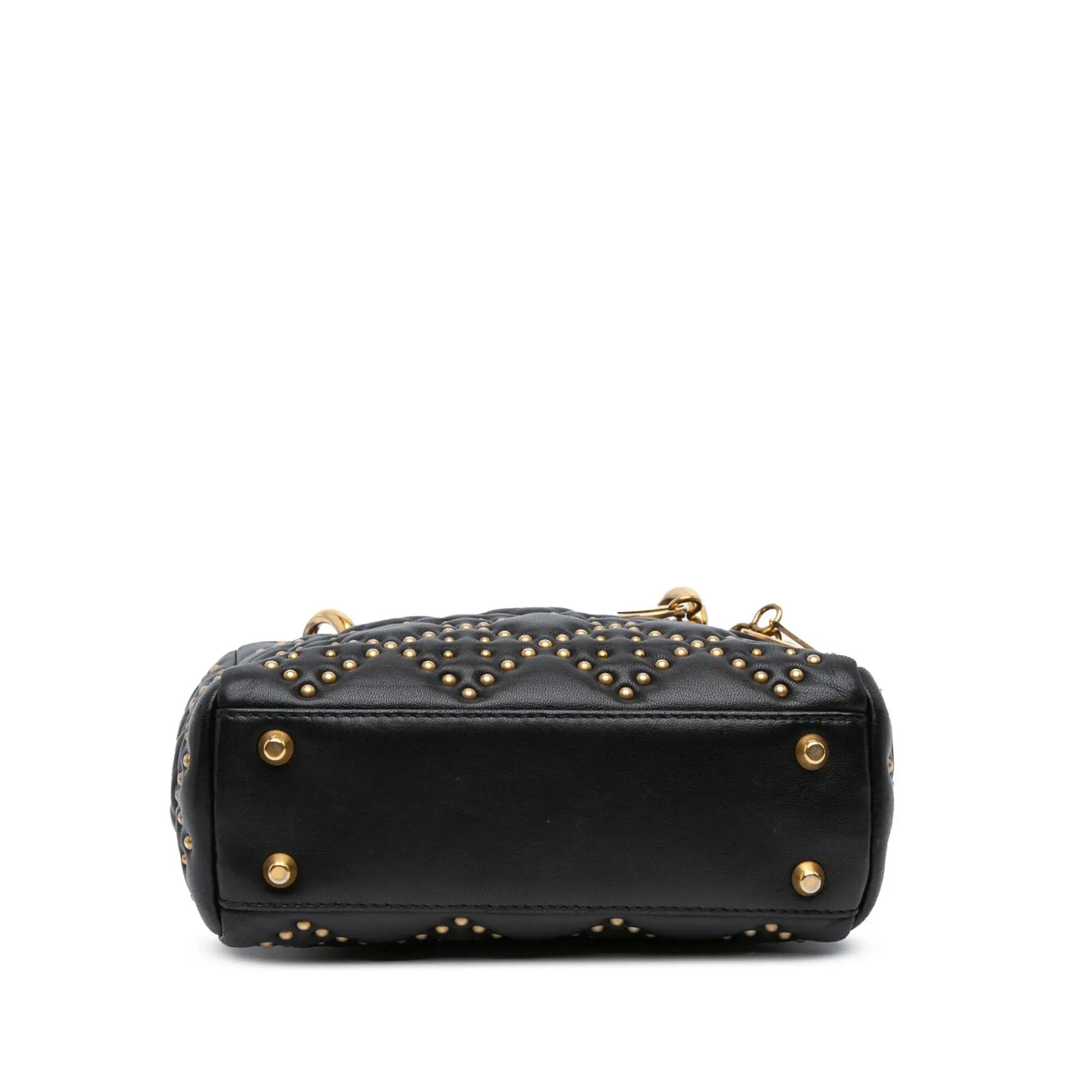 Bottom-panel-of-the-Mini-Lady-Dior-Black-Studded-Supple-Cannage-Calfskin-with-four-gold-tone-metal-feet-on-the-base.