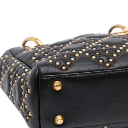 Close-up-details-of-the-bottom-panel-of-the-Mini-Lady-Dior-Black-Studded-Supple-Cannage-Calfskin-with-four-gold-tone-metal-feet-on-the-base.