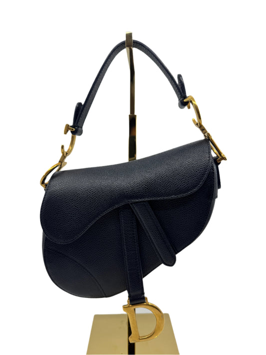 Front-of-the-Dior-Saddle-Bag-Black-Mini-with-"CD"-hardware-in-gold-on-the-sides-and-"D"-in-gold-on-the-front-flap