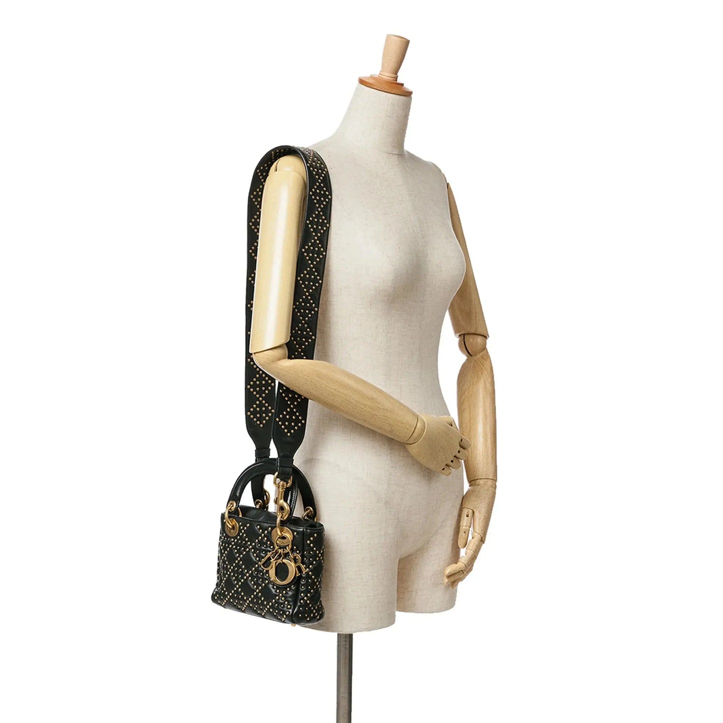 Full-view-of-the-Mini-Lady-Dior-Black-Studded-Supple-Cannage-Calfskin-with-shoulder-strap-on-a-mannequin.