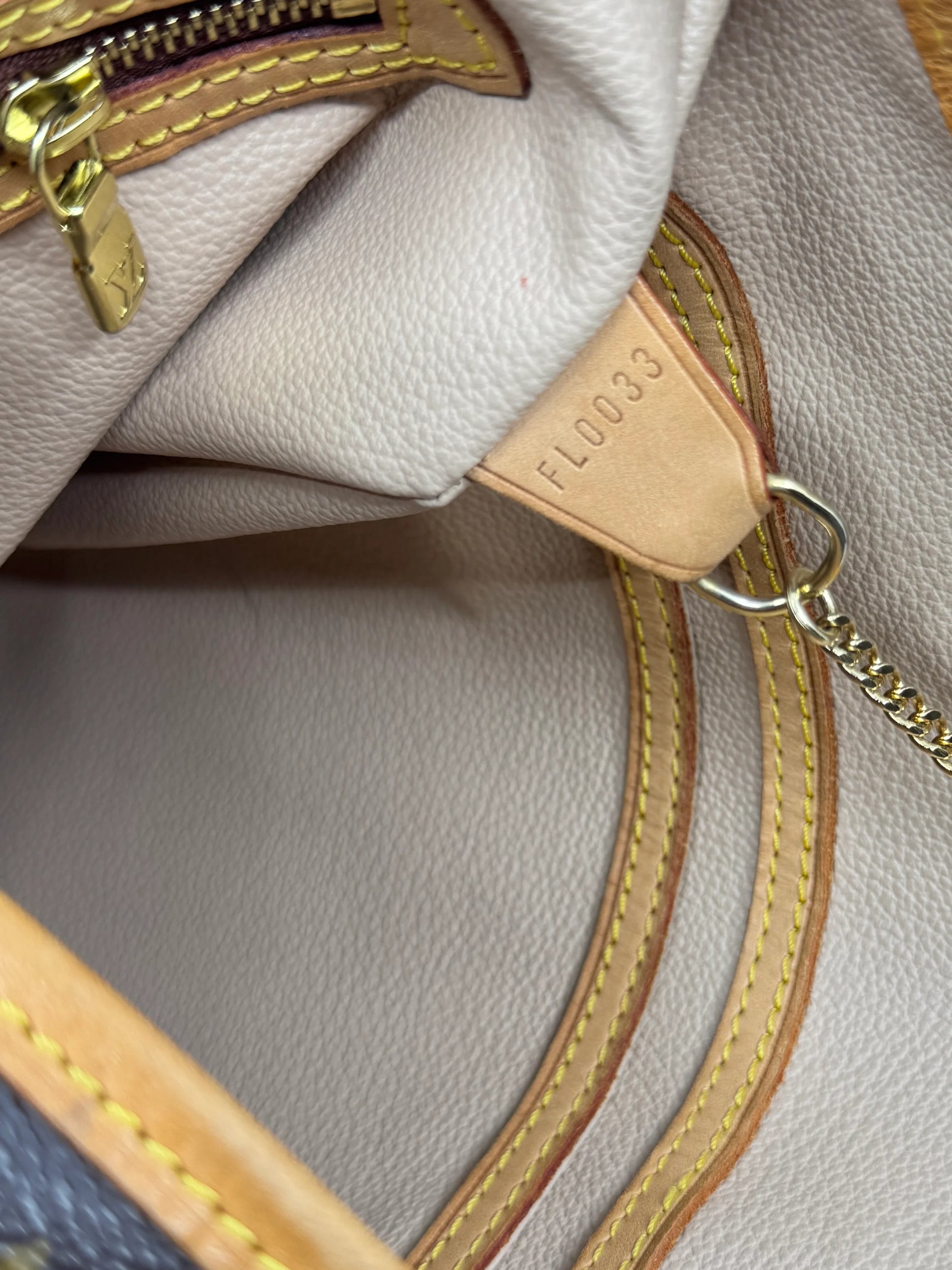 interior-leather-tag-of-louis-vuitton-monogram-petit-bucket-bag-with-serial-number-FL0033