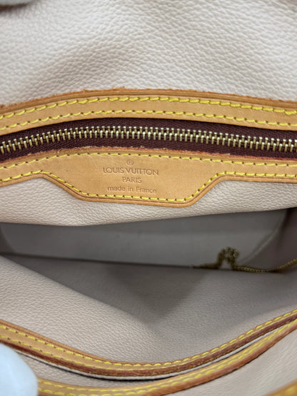 interior-of-golden-closure-of-louis-vuitton-monogram-petit-bucket-bag-with-authenticity-tag-and-made-in-france-label